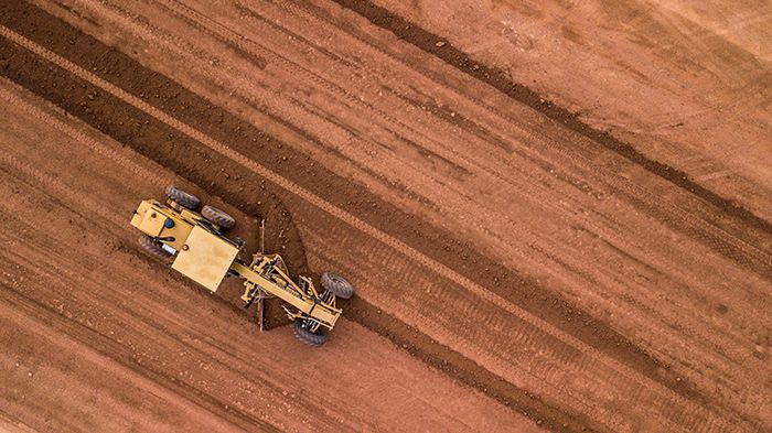 Aerial top view tractor at work.