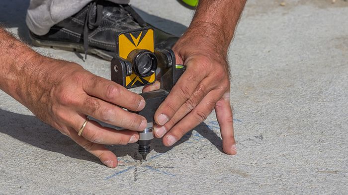 Total station prism with survey worker hands 2